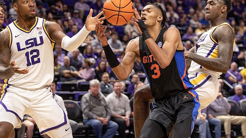 Jan 10, 2023; Baton Rouge, Louisiana, USA; Florida Gators forward Alex Fudge (3) dribbles against LSU Tigers forward KJ Williams (12) during the first half at Pete Maravich Assembly Center. Mandatory Credit: Stephen Lew-USA TODAY Sports