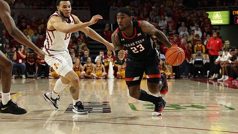 Jan 10, 2023; Ames, Iowa, USA; Texas Tech Red Raiders guard De'Vion Harmon (23) drives past Iowa State Cyclones guard Jaren Holmes (13) at James H. Hilton Coliseum. Mandatory Credit: Reese Strickland-USA TODAY Sports