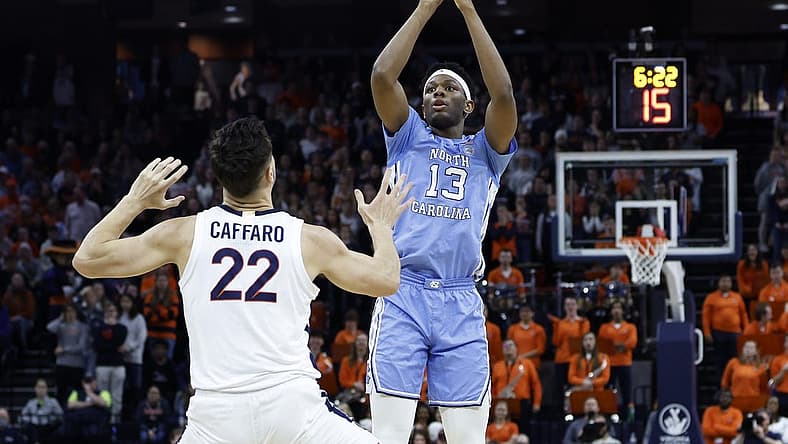 Jan 10, 2023; Charlottesville, Virginia, USA; North Carolina Tar Heels forward Jalen Washington (13) shoots the ball over Virginia Cavaliers center Francisco Caffaro (22) in the first half at John Paul Jones Arena. Mandatory Credit: Geoff Burke-USA TODAY Sports