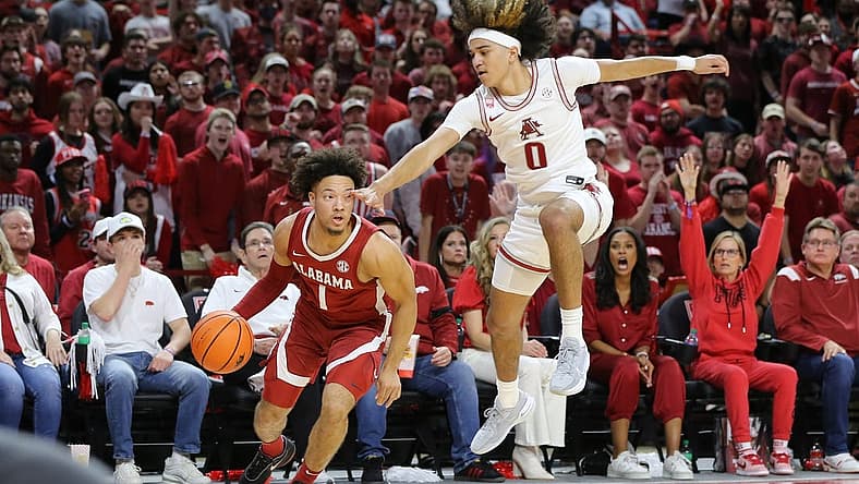 Jan 11, 2023; Fayetteville, Arkansas, USA; Alabama Crimson Tide guard Mark Sears (1) controls the ball as Arkansas Razorbacks guard Anthony Black (0) defends during the first half at Bud Walton Arena. Mandatory Credit: Nelson Chenault-USA TODAY Sports