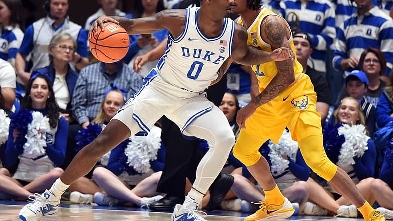 Jan 11, 2023; Durham, North Carolina, USA;Duke Blue Devils forward Dariq Whitehead(0) controls the ball as Pittsburgh Panthers guard Nike Sibande (22) defends during the first half at Cameron Indoor Stadium. Mandatory Credit: Rob Kinnan-USA TODAY Sports
