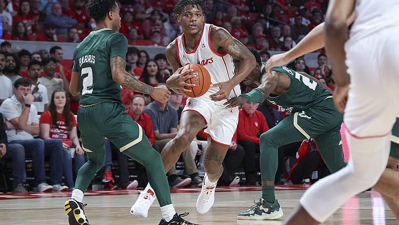 Jan 11, 2023; Houston, Texas, USA; Houston Cougars guard Marcus Sasser (0) drives with the ball as South Florida Bulls guard Tyler Harris (2) defends during the first half at Fertitta Center. Mandatory Credit: Troy Taormina-USA TODAY Sports