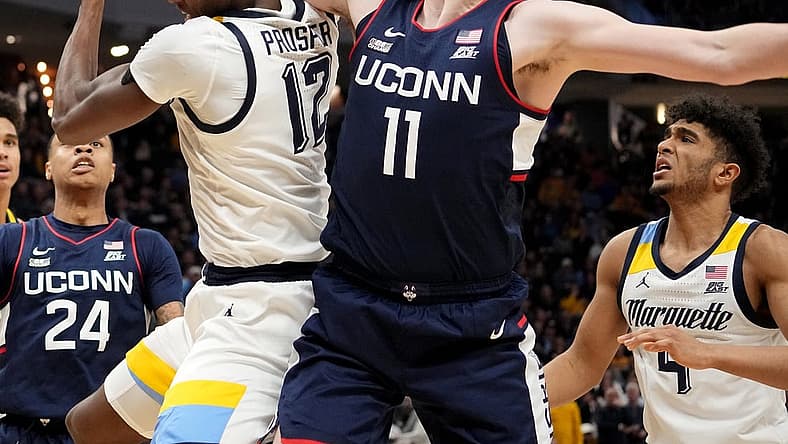 Jan 11, 2023; Milwaukee, Wisconsin, USA; Marquette forward Olivier-Maxence Prosper (12) and Connecticut forward Alex Karaban (11) battle for a rebound during the second half at Fiserv Forum. Mandatory Credit: Mark Hoffman-USA TODAY Sports