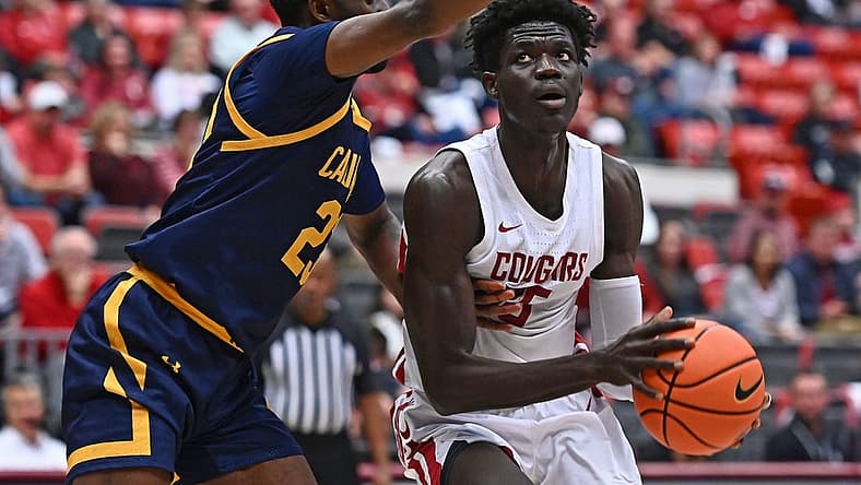 Jan 11, 2023; Pullman, Washington, USA; Washington State Cougars forward Mouhamed Gueye (35) shoots the ball against California Golden Bears forward Obinna Anyanwu (23) in the first half at Friel Court at Beasley Coliseum. Mandatory Credit: James Snook-USA TODAY Sports