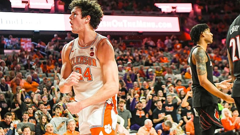 Jan 11, 2023; Clemson, South Carolina, USA; Clemson Tigers forward PJ Hall (24) celebrates near Louisville Cardinals forward Sydney Curry (21) after scoring and being fouled during the second half at Littlejohn Coliseum. Mandatory Credit: Ken Ruinard-USA TODAY Sports
