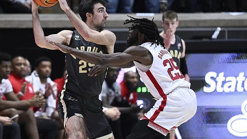 Jan 13, 2023; West Lafayette, Indiana, USA; Nebraska Cornhuskers guard Emmanuel Bandoumel (25) reaches for a ball in the hands of Purdue Boilermakers guard Ethan Morton (25) during the first half at Mackey Arena. Mandatory Credit: Marc Lebryk-USA TODAY Sports