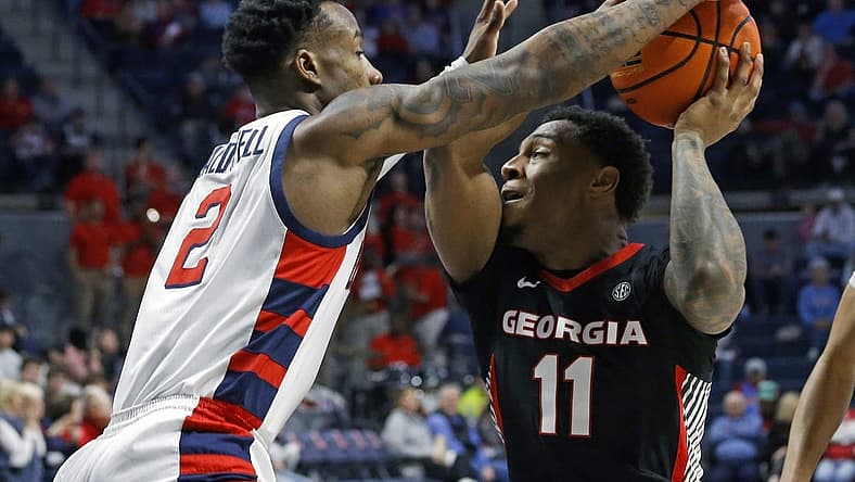 Jan 14, 2023; Oxford, Mississippi, USA; Georgia Bulldogs guard Justin Hill (11) drives to the basket against Mississippi Rebels guard TJ Caldwell (2) during the first half at The Sandy and John Black Pavilion at Ole Miss. Mandatory Credit: Petre Thomas-USA TODAY Sports
