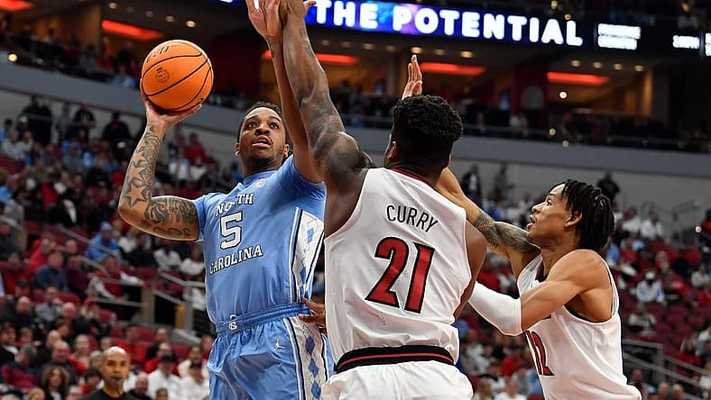 North Carolina forward Armando Bacot (5) shoots over Louisville forward Sydney Curry (21) and forward JJ Traynor (12) during the first half of an NCAA college basketball game in Louisville, Ky., Saturday, Jan. 14, 2023.
Armando Bacot Sydney Curry