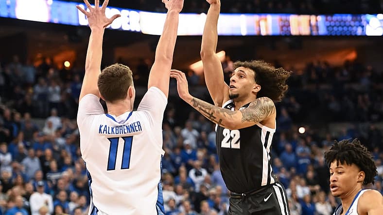 Jan 14, 2023; Omaha, Nebraska, USA; Providence Friars guard Devin Carter (22) scores over Creighton Bluejays center Ryan Kalkbrenner (11) in the first half at CHI Health Center Omaha. Mandatory Credit: Steven Branscombe-USA TODAY Sports