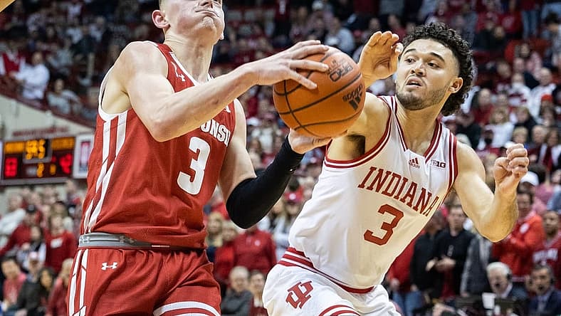 Jan 14, 2023; Bloomington, Indiana, USA; Wisconsin Badgers guard Connor Essegian (3) shoots the ball against Indiana Hoosiers guard Anthony Leal (3) in the second half at Simon Skjodt Assembly Hall. Mandatory Credit: Trevor Ruszkowski-USA TODAY Sports