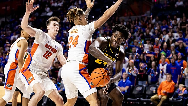 Jan 14, 2023; Gainesville, Florida, USA; Missouri Tigers guard Kobe Brown (24) passes around Florida Gators guard Riley Kugel (24) during the first half at Exactech Arena at the Stephen C. O'Connell Center. Mandatory Credit: Matt Pendleton-USA TODAY Sports