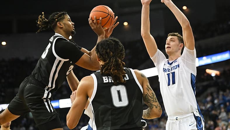 Jan 14, 2023; Omaha, Nebraska, USA; Providence Friars forward Bryce Hopkins (23) attempts an off balanced shot against Creighton Bluejays center Ryan Kalkbrenner (11) in the second half at CHI Health Center Omaha. Mandatory Credit: Steven Branscombe-USA TODAY Sports