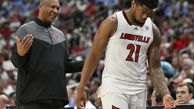 Jan 14, 2023; Louisville, Kentucky, USA; Louisville Cardinals forward Sydney Curry (21) receives instruction from head coach Kenny Payne as he heads to the bench during the second half against the North Carolina Tar Heels at KFC Yum! Center. North Carolina defeated Louisville 80-59. Mandatory Credit: Jamie Rhodes-USA TODAY Sports
