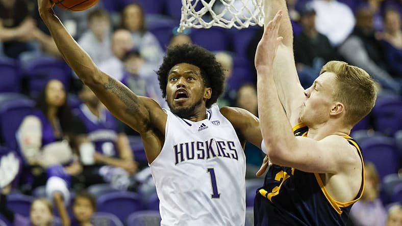 Jan 14, 2023; Seattle, Washington, USA; Washington Huskies forward Keion Brooks (1) rises for a layup attempt against California Golden Bears forward Lars Thiemann (21) during the first half at Alaska Airlines Arena at Hec Edmundson Pavilion. Mandatory Credit: Joe Nicholson-USA TODAY Sports