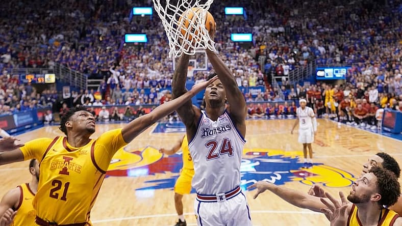 Jan 14, 2023; Lawrence, Kansas, USA; Kansas Jayhawks forward K.J. Adams Jr. (24) shoots as Iowa State Cyclones center Osun Osunniyi (21) defends during the second half at Allen Fieldhouse. Mandatory Credit: Denny Medley-USA TODAY Sports