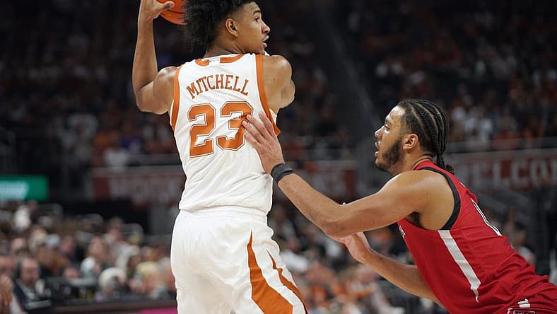 Jan 14, 2023; Austin, Texas, USA; Texas Longhorns forward Dillon Mitchell (23) looks to pass against Texas Tech Red Raiders forward Kevin Obanor (0) during the first half at Moody Center. Mandatory Credit: Dustin Safranek-USA TODAY Sports