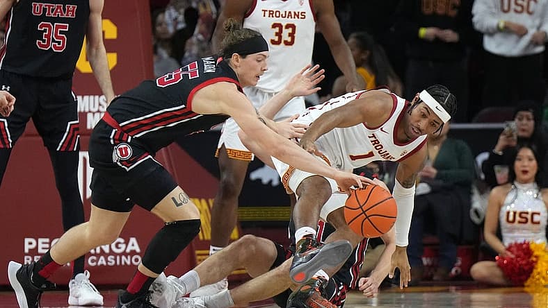 Jan 14, 2023; Los Angeles, California, USA; Southern California Trojans guard Malik Thomas (1) and Utah Utes guard Gabe Madsen (55) battle for the ball in the first half at Galen Center. Mandatory Credit: Kirby Lee-USA TODAY Sports