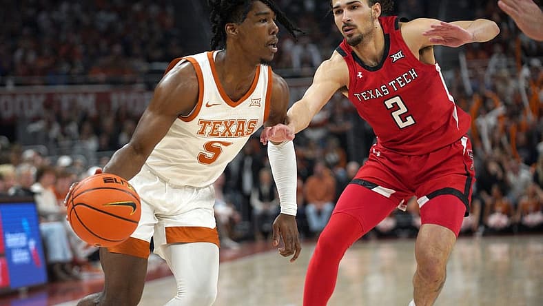 Jan 14, 2023; Austin, Texas, USA; Texas Longhorns guard Marcus Carr (5) dribbles against Texas Tech Red Raiders guard Pop Isaacs (2) during the first half at Moody Center. Mandatory Credit: Dustin Safranek-USA TODAY Sports