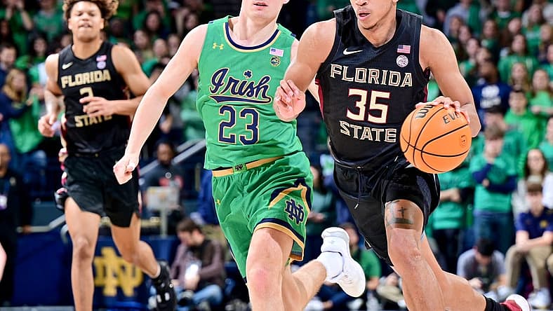 Jan 17, 2023; South Bend, Indiana, USA; Florida State Seminoles guard Matthew Cleveland (35) dribbles as Notre Dame Fighting Irish guard Dane Goodwin (23) defends in the first half at the Purcell Pavilion. Mandatory Credit: Matt Cashore-USA TODAY Sports