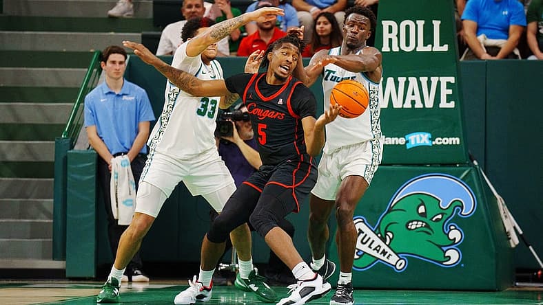 Jan 17, 2023; New Orleans, Louisiana, USA; Houston Cougars forward Ja'Vier Francis (5) fights for a rebound Tulane Green Wave forward Tylan Pope (33) during the second half at Avron B. Fogelman Arena in Devlin Fieldhouse. Mandatory Credit: Andrew Wevers-USA TODAY Sports