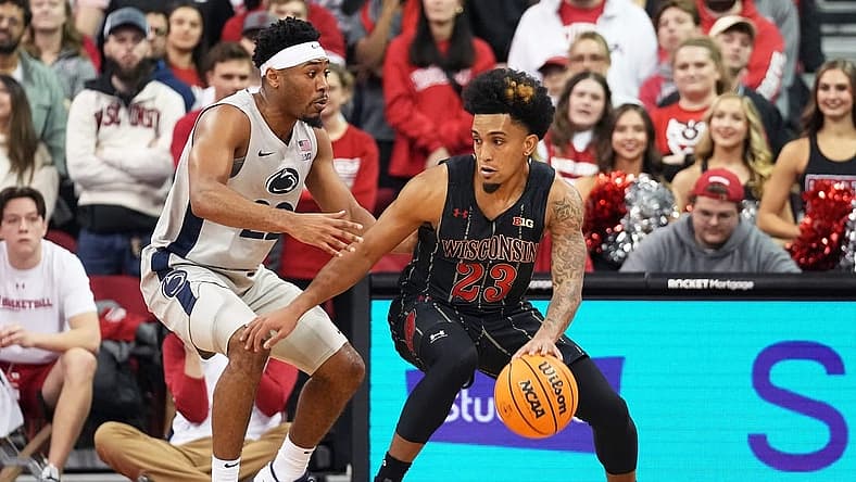 Jan 17, 2023; Madison, Wisconsin, USA; Wisconsin Badgers guard Chucky Hepburn (23) dribbles the ball under coverage by Penn State Nittany Lions guard Jalen Pickett (22) during the first half at the Kohl Center. Mandatory Credit: Kayla Wolf-USA TODAY Sports