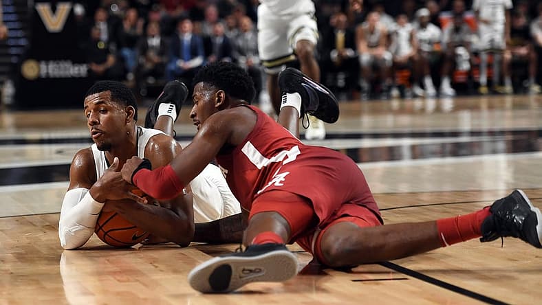 Jan 17, 2023; Nashville, Tennessee, USA; Vanderbilt Commodores guard Jordan Wright (4) dives for a ball against Alabama Crimson Tide guard Jaden Bradley (0) during the first half at Memorial Gymnasium. Mandatory Credit: Christopher Hanewinckel-USA TODAY Sports