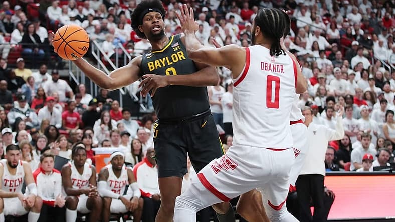Jan 17, 2023; Lubbock, Texas, USA;  Baylor Bears forward Flo Thumb (0) passes the ball in front of the Texas Tech Red Raiders forward Kevin Obanor (0) in the first half at United Supermarkets Arena. Mandatory Credit: Michael C. Johnson-USA TODAY Sports