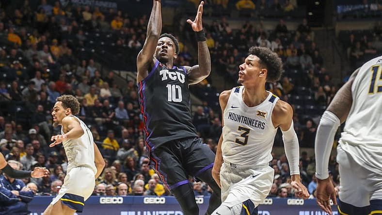 Jan 18, 2023; Morgantown, West Virginia, USA; TCU Horned Frogs guard Damion Baugh (10) shoots in the lane against West Virginia Mountaineers forward Tre Mitchell (3) during the first half at WVU Coliseum. Mandatory Credit: Ben Queen-USA TODAY Sports