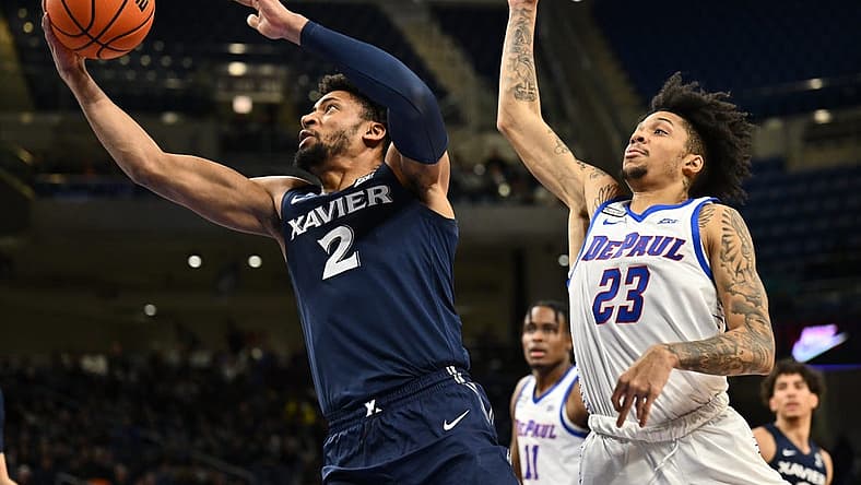 Jan 18, 2023; Chicago, Illinois, USA; Xavier Musketeers forward Jerome Hunter (2) sails past DePaul Blue Demons guard Caleb Murphy (23) for a lay up in the first half at Wintrust Arena. Mandatory Credit: Jamie Sabau-USA TODAY Sports
