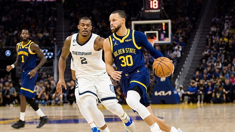 Jan 25, 2023; San Francisco, California, USA; Golden State Warriors guard Stephen Curry (30) dribbles past Memphis Grizzlies center Xavier Tillman Sr. (2) during the first half at Chase Center. Mandatory Credit: John Hefti-USA TODAY Sports