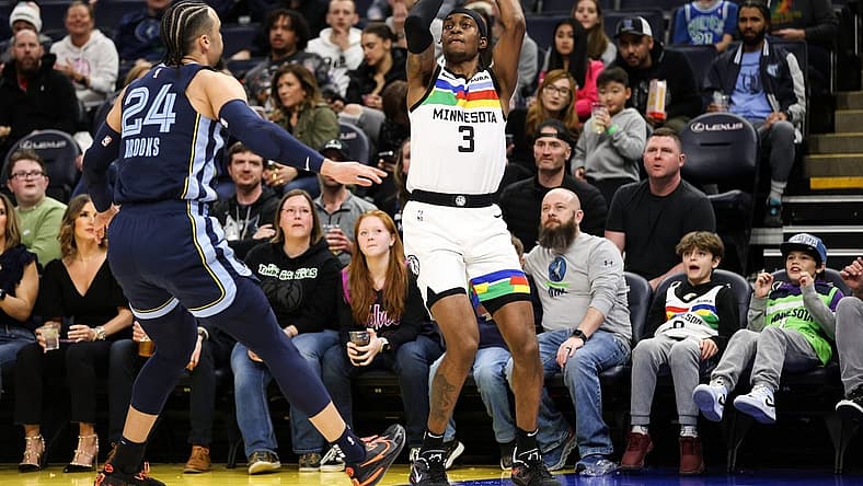 Jan 27, 2023; Minneapolis, Minnesota, USA; Minnesota Timberwolves forward Jaden McDaniels (3) shoots while Memphis Grizzlies forward Dillon Brooks (24) defends during the first quarter at Target Center. Mandatory Credit: Matt Krohn-USA TODAY Sports