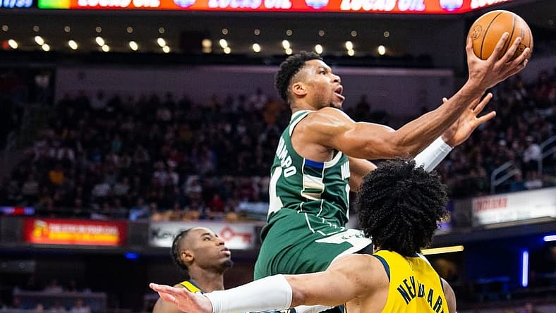 Jan 27, 2023; Indianapolis, Indiana, USA; Milwaukee Bucks forward Giannis Antetokounmpo (34) shoots the ball while Indiana Pacers guard Andrew Nembhard (2) defends in the second half at Gainbridge Fieldhouse. Mandatory Credit: Trevor Ruszkowski-USA TODAY Sports