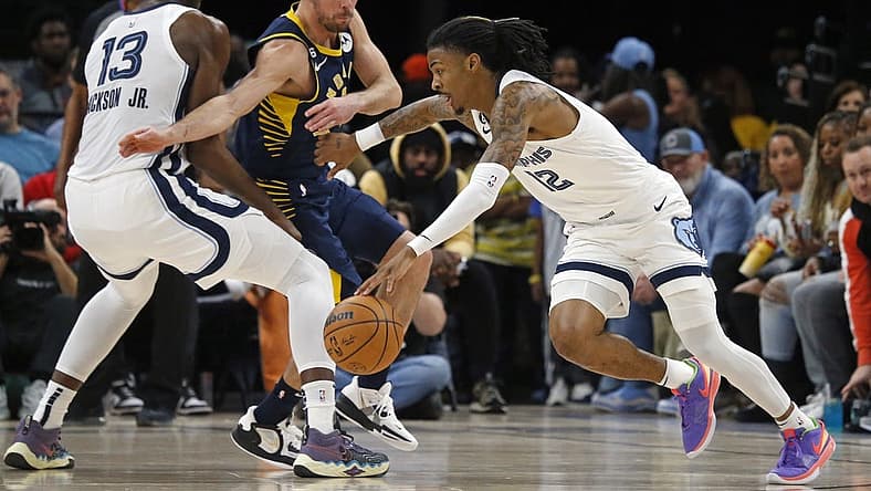 Jan 29, 2023; Memphis, Tennessee, USA; Memphis Grizzlies guard Ja Morant (12) dribbles around a screen set by forward Jaren Jackson Jr. (13) on Indiana Pacers guard T.J. McConnell (9) during the first half at FedExForum. Mandatory Credit: Petre Thomas-USA TODAY Sports
