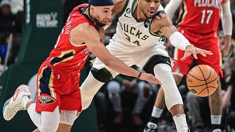 Jan 29, 2023; Milwaukee, Wisconsin, USA; Milwaukee Bucks forward Giannis Antetokounmpo (34) and New Orleans Pelicans guard Jose Alvarado (15) reach for a loose ball in the first quarter at Fiserv Forum. Mandatory Credit: Benny Sieu-USA TODAY Sports