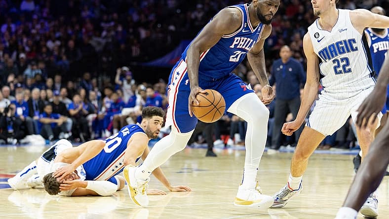 Jan 30, 2023; Philadelphia, Pennsylvania, USA; Philadelphia 76ers center Joel Embiid (21) dribbles the ball after a pass from Georges Niang (20) against Orlando Magic center Moritz Wagner (21) in front of forward Franz Wagner (22) during the fourth quarter at Wells Fargo Center. Mandatory Credit: Bill Streicher-USA TODAY Sports