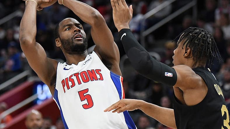 Nov 27, 2022; Detroit, Michigan, USA; Detroit Pistons guard Alec Burks (5) puts up shot over Cleveland Cavaliers guard Isaac Okoro (35) in the third quarter at Little Caesars Arena. Mandatory Credit: Lon Horwedel-USA TODAY Sports