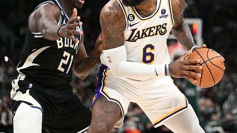 Dec 2, 2022; Milwaukee, Wisconsin, USA; Los Angeles Lakers forward LeBron James (6) posts up against Milwaukee Bucks guard Jrue Holiday (21) in the second quarter at Fiserv Forum. Mandatory Credit: Michael McLoone-USA TODAY Sports