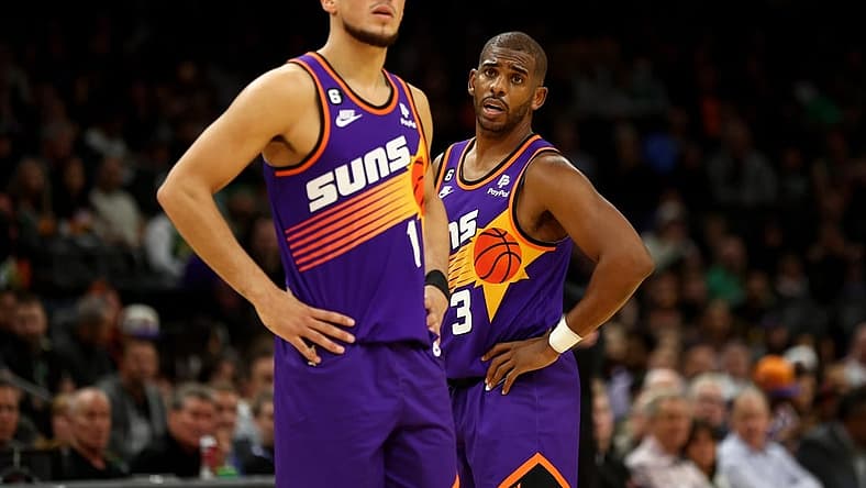 Dec 7, 2022; Phoenix, Arizona, USA; Phoenix Suns guard Devin Booker (1) and Chris Paul (3) against the Boston Celtics at Footprint Center. Mandatory Credit: Mark J. Rebilas-USA TODAY Sports