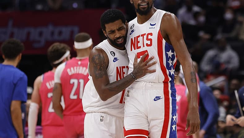 Dec 12, 2022; Washington, District of Columbia, USA; Brooklyn Nets guard Kyrie Irving (11) celebrates with Nets forward Kevin Durant (7) against the Washington Wizards in the fourth quarter at Capital One Arena. Mandatory Credit: Geoff Burke-USA TODAY Sports