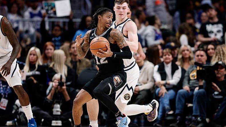 Dec 20, 2022; Denver, Colorado, USA; Memphis Grizzlies guard Ja Morant (12) controls the ball as Denver Nuggets guard Christian Braun (0) guards in the third quarter at Ball Arena. Mandatory Credit: Isaiah J. Downing-USA TODAY Sports
