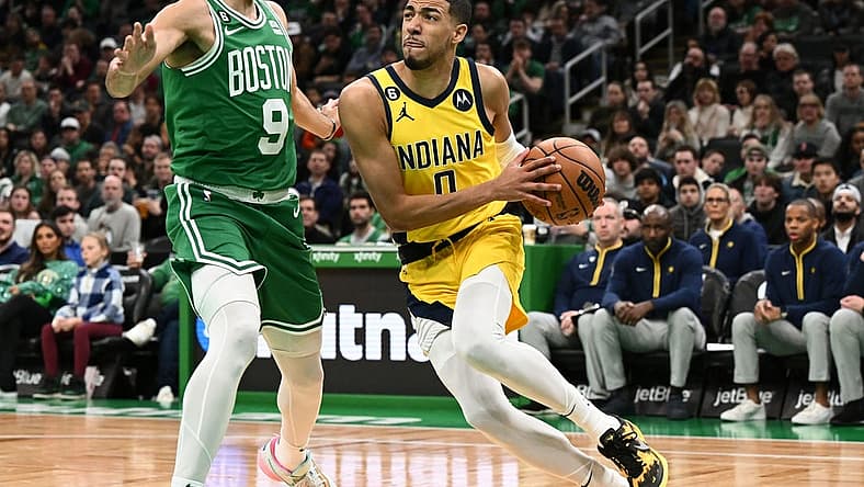 Dec 21, 2022; Boston, Massachusetts, USA; Indiana Pacers guard Tyrese Haliburton (0) drives to the basket against Boston Celtics guard Derrick White (9) during the first quarter at the TD Garden. Mandatory Credit: Brian Fluharty-USA TODAY Sports