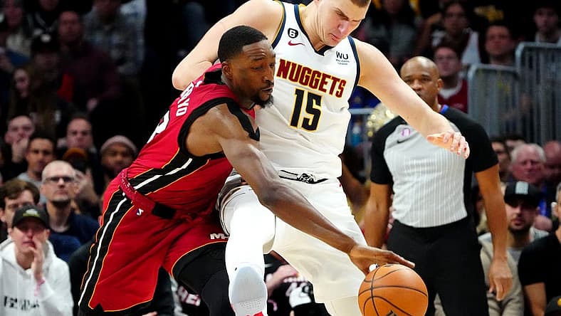 Dec 30, 2022; Denver, Colorado, USA; Miami Heat center Bam Adebayo (13) steals the ball away from Denver Nuggets center Nikola Jokic (15) in the second half at Ball Arena. Mandatory Credit: Ron Chenoy-USA TODAY Sports