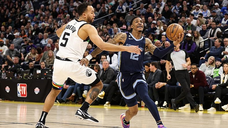 Jan 27, 2023; Minneapolis, Minnesota, USA; Memphis Grizzlies guard Ja Morant (12) drives to the basket while Minnesota Timberwolves forward Kyle Anderson (5) defends during the fourth quarter at Target Center. Mandatory Credit: Matt Krohn-USA TODAY Sports
