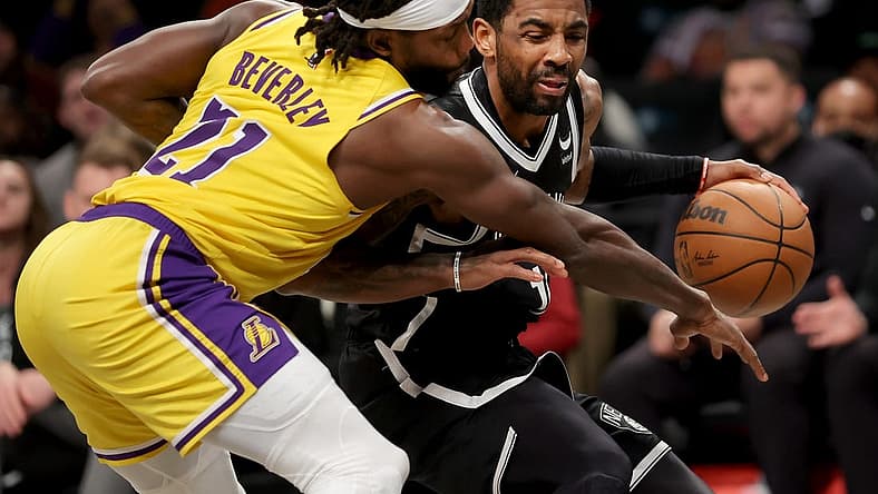 Jan 30, 2023; Brooklyn, New York, USA; Brooklyn Nets guard Kyrie Irving (11) is fouled as he brings the ball up court by Los Angeles Lakers guard Patrick Beverley (21) during the second quarter at Barclays Center. Mandatory Credit: Brad Penner-USA TODAY Sports