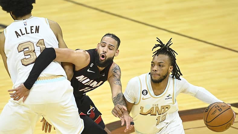 Jan 31, 2023; Cleveland, Ohio, USA; Miami Heat forward Caleb Martin (16) tries to get between Cleveland Cavaliers center Jarrett Allen (31) and guard Darius Garland (10) in the fourth quarter at Rocket Mortgage FieldHouse. Mandatory Credit: David Richard-USA TODAY Sports