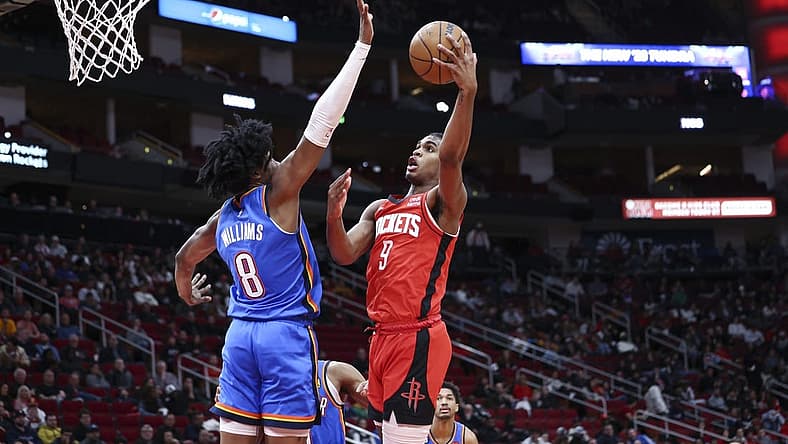 Feb 1, 2023; Houston, Texas, USA; Houston Rockets guard Josh Christopher (9) attempts to score a basket as Oklahoma City Thunder forward Jalen Williams (8) defends during the second quarter at Toyota Center. Mandatory Credit: Troy Taormina-USA TODAY Sports