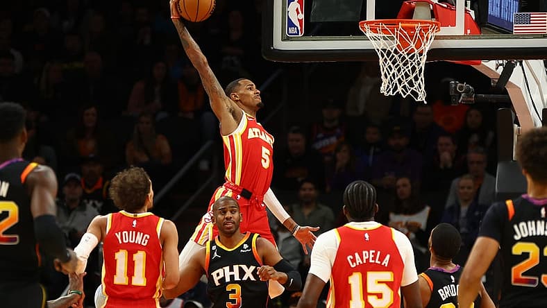 Feb 1, 2023; Phoenix, Arizona, USA; Atlanta Hawks guard Dejounte Murray (5) slam dunks the ball against the Phoenix Suns in the first half at Footprint Center. Mandatory Credit: Mark J. Rebilas-USA TODAY Sports