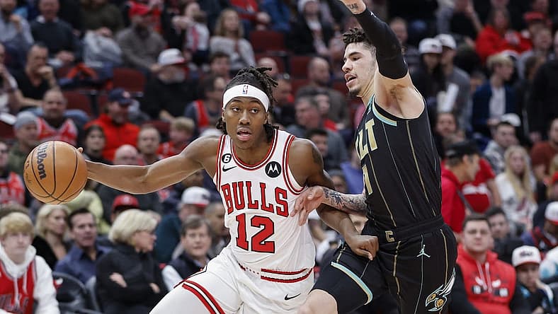 Feb 2, 2023; Chicago, Illinois, USA; Chicago Bulls guard Ayo Dosunmu (12) drives to the basket against Charlotte Hornets guard LaMelo Ball (1) during the first half at United Center. Mandatory Credit: Kamil Krzaczynski-USA TODAY Sports