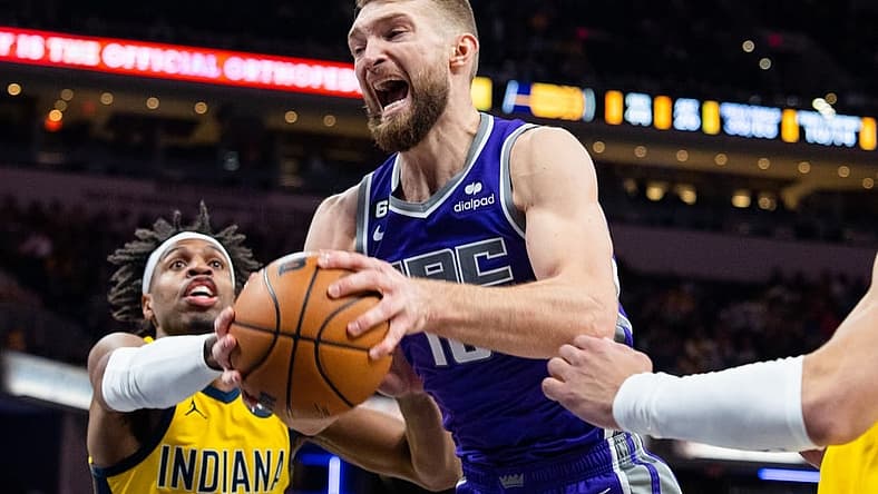 Feb 3, 2023; Indianapolis, Indiana, USA; Sacramento Kings forward Domantas Sabonis (10) rebounds the ball while  Indiana Pacers guard Buddy Hield (24) defends in the second half at Gainbridge Fieldhouse. Mandatory Credit: Trevor Ruszkowski-USA TODAY Sports