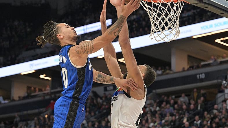 Feb 3, 2023; Minneapolis, Minnesota, USA; Orlando Magic guard Cole Anthony (50) goes to the basket as Minnesota Timberwolves center Rudy Gobert (27) defends during the second quarter at Target Center. Mandatory Credit: Jeffrey Becker-USA TODAY Sports